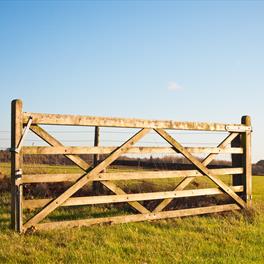 Timber field gate in field.