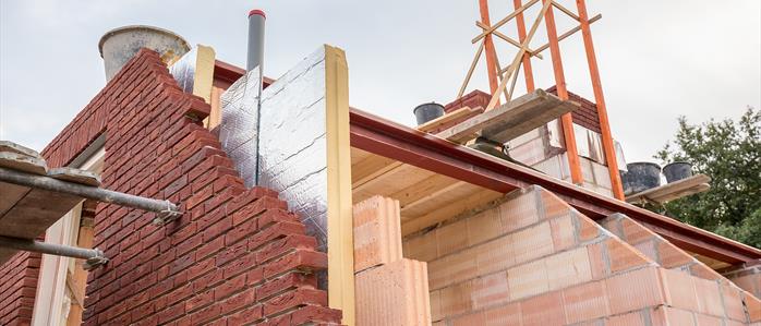Insulation board between bricks and inside timbers.