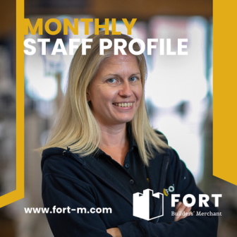 Portrait of FORT Builders' Merchant staff member wearing uniform and smiling at camera. Blurred out background.