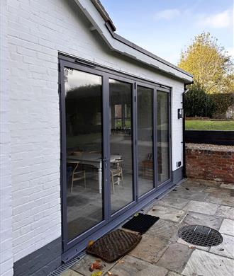 Origin Bi-fold door fitted onto existing extension & supplied by FORT Builders' Merchant. 