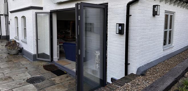 Origin Bi-fold door fitted onto existing extension & supplied by FORT Builders' Merchant. 