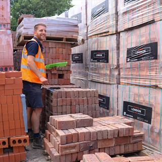 FORT employee counting stock of bricks. 