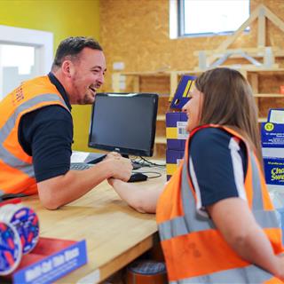 FORT employees competing in an arm wrestling match. 
