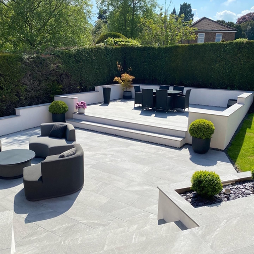 Image displaying Enta porcelain paving imagery with outdoor furniture laid.