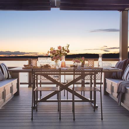 A beautiful decking space with Clam Shell installed, set with a picturesque backdrop of the ocean. 