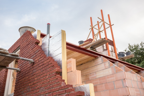 Insulation board between bricks and inside timbers.