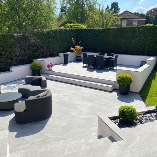 Image displaying Enta porcelain paving imagery with outdoor furniture laid. 