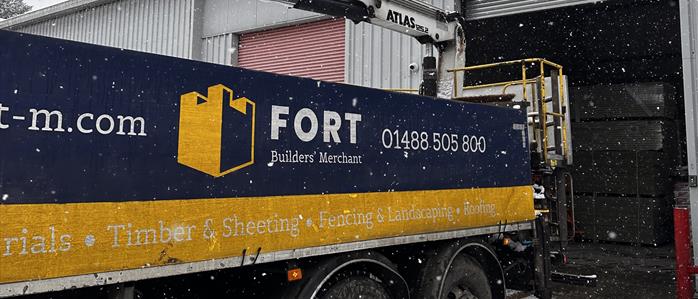 Snowy picture of a FORT truck parked at FORT Builders' Merchant Unit B. 