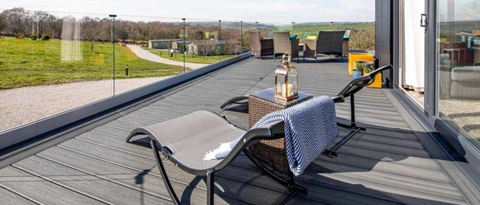 A picturesque scene overlooking British countryside. A raised deck made from Island Mist Trex Composite boards.  