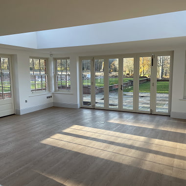 Construction project completed from FORT Builders' Merchant materials, bespoke oak finished floor with French open view doors.